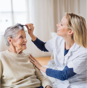 nurse comb the hair of elderly woman