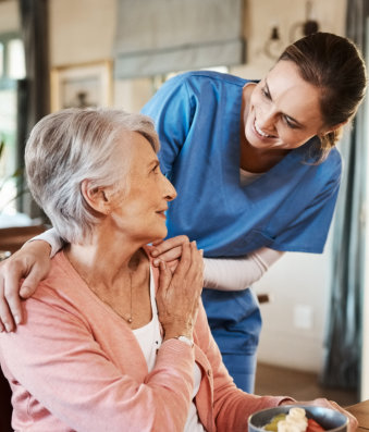 nurse comforting elderly woman