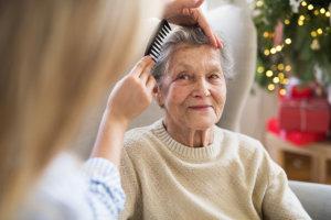 caregiver comb her patient's hair