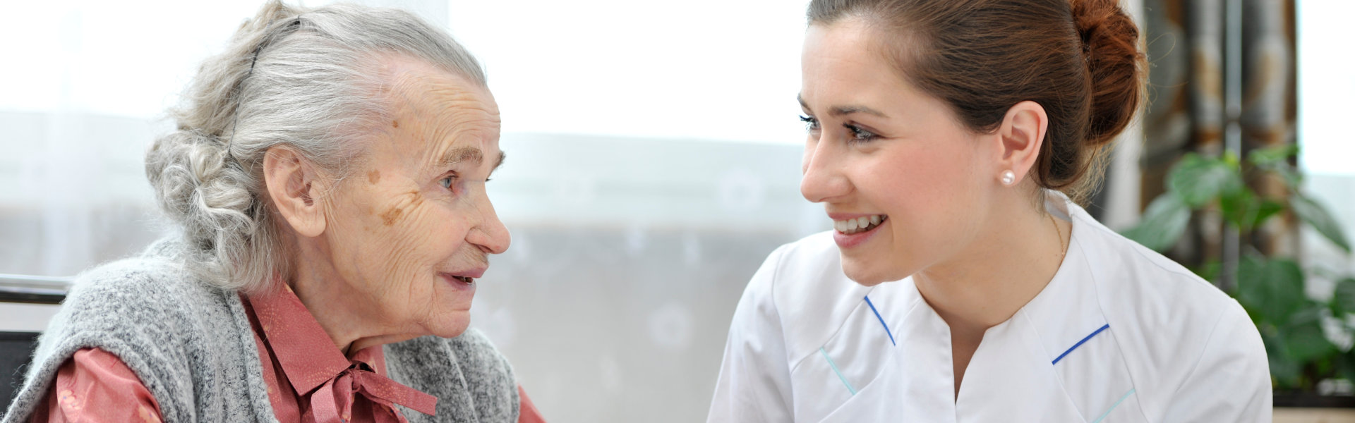 caregiver assist her patient in eating breakfast