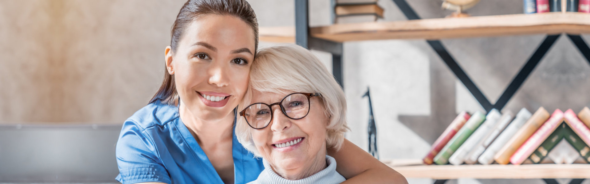 elderly woman and nurse smiling