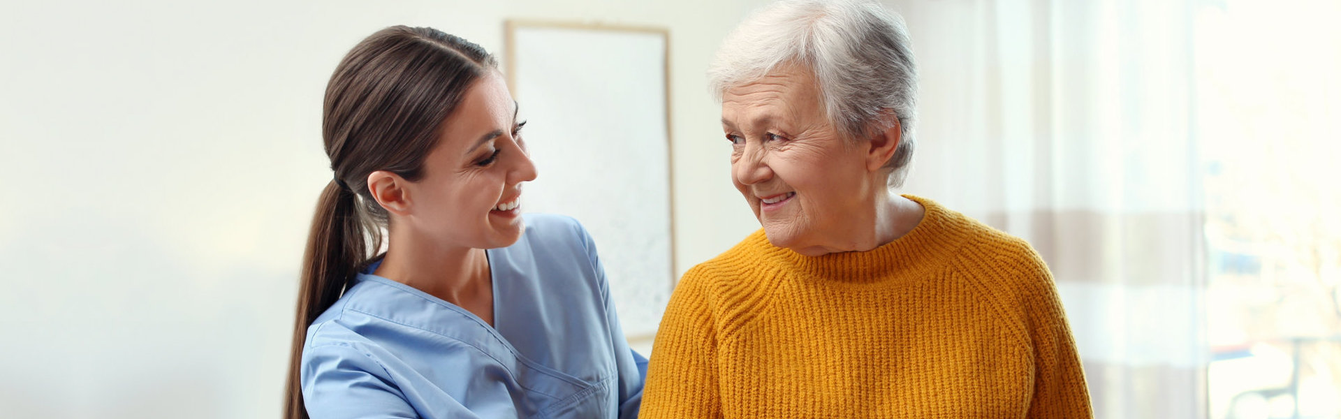 nurse assisting elderly woman