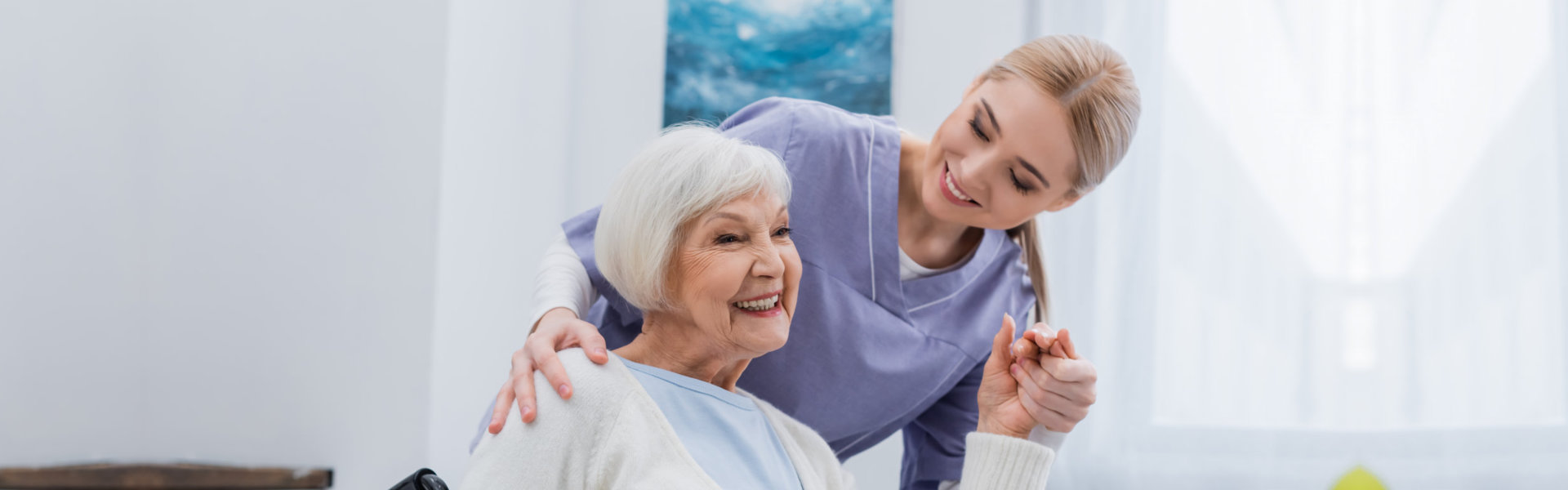 nurse and elderly woman smiling